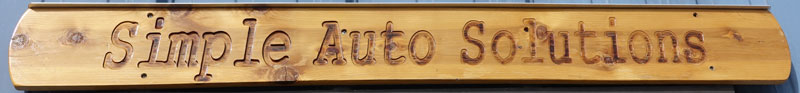 Image of a wooden sign over the front door at the SAS Porsche repair shop.
